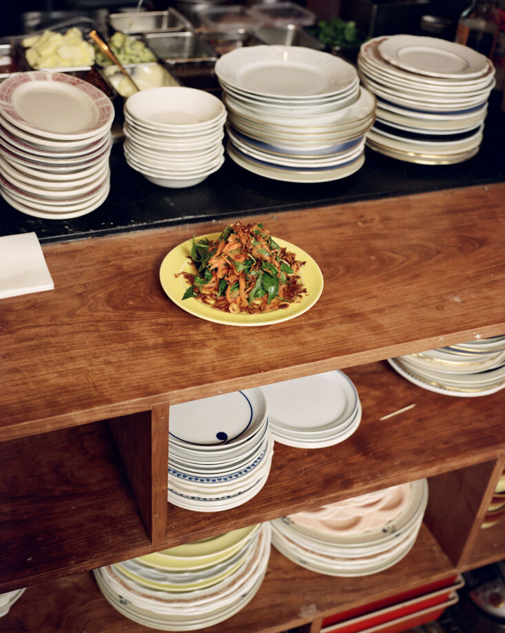 Mismatched vintage porcelain plates used for serving Vietnamese-French dishes.