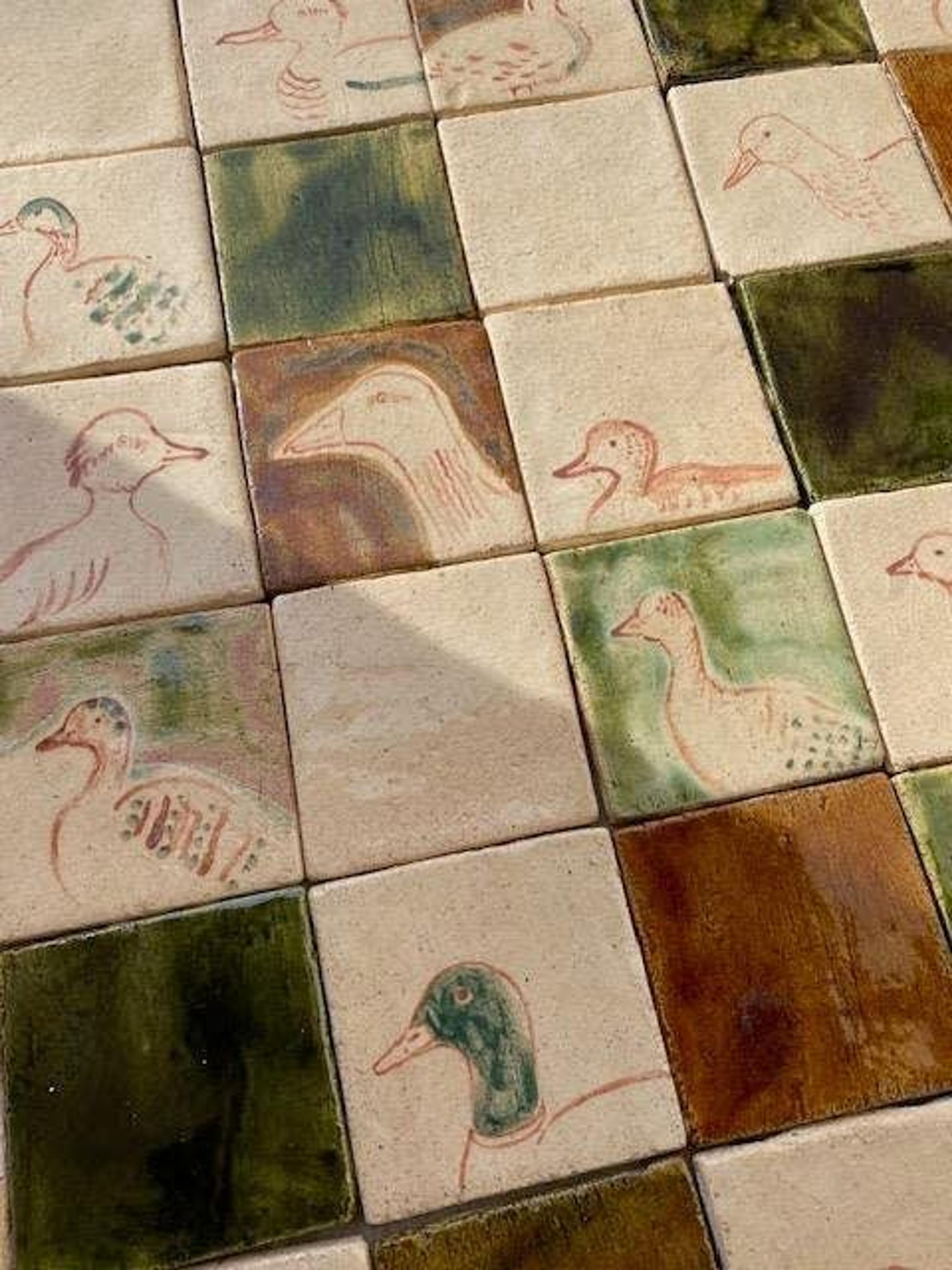 Close-up of green handmade artisanal tiles with rich texture.