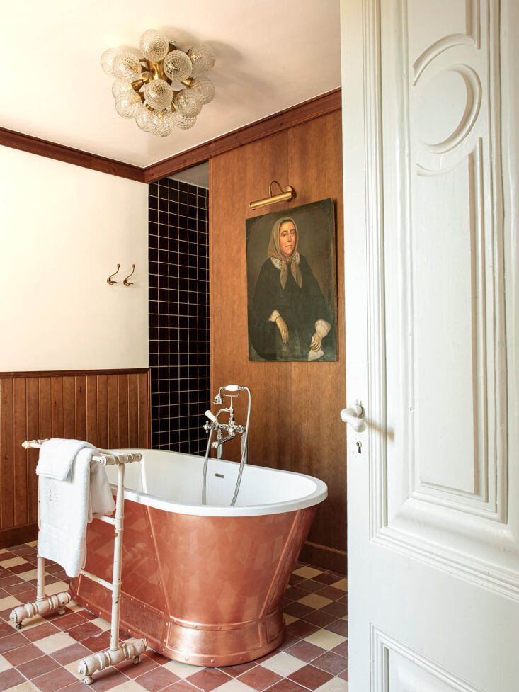 An interior shot showing the seamless transition between historic structural arches and modern luxury furnishings.