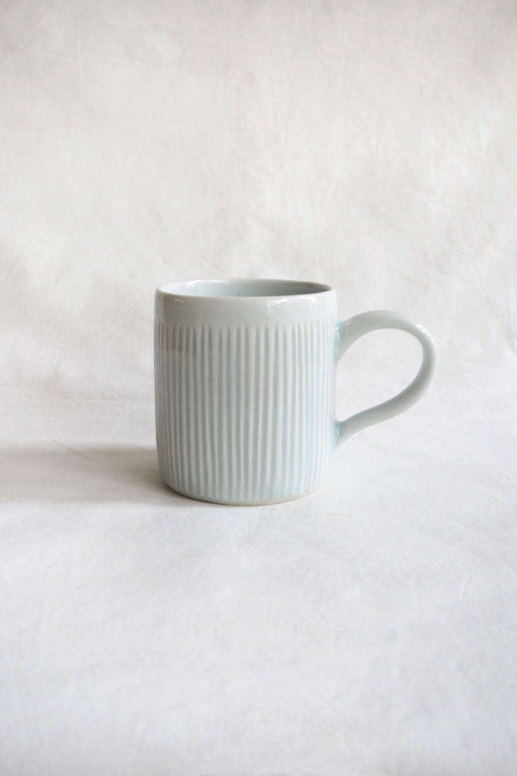 A soft blue-grey ceramic mug with vertical ridges showcasing minimalist Japanese design.
