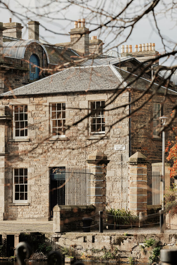 Exterior view of the historic 1811 Customs House in Leith, Edinburgh, overlooking the water.