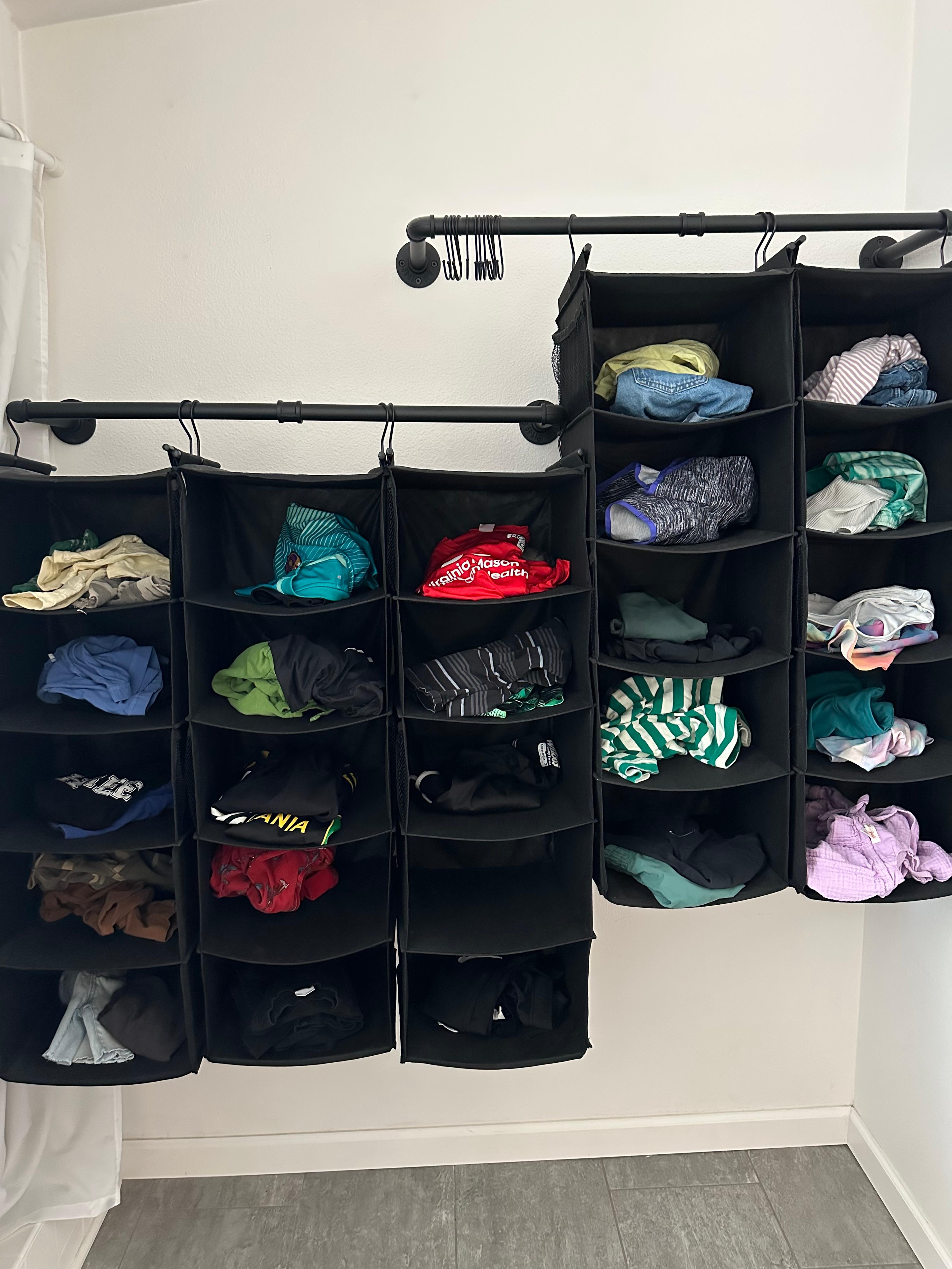 A hanging shoe organizer used for storing daily outfits including accessories.