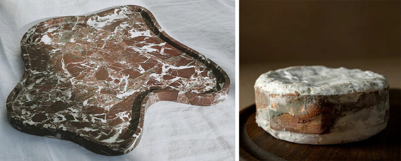 A marbled serving tray next to a rustic cheese wheel on a dark wooden table.