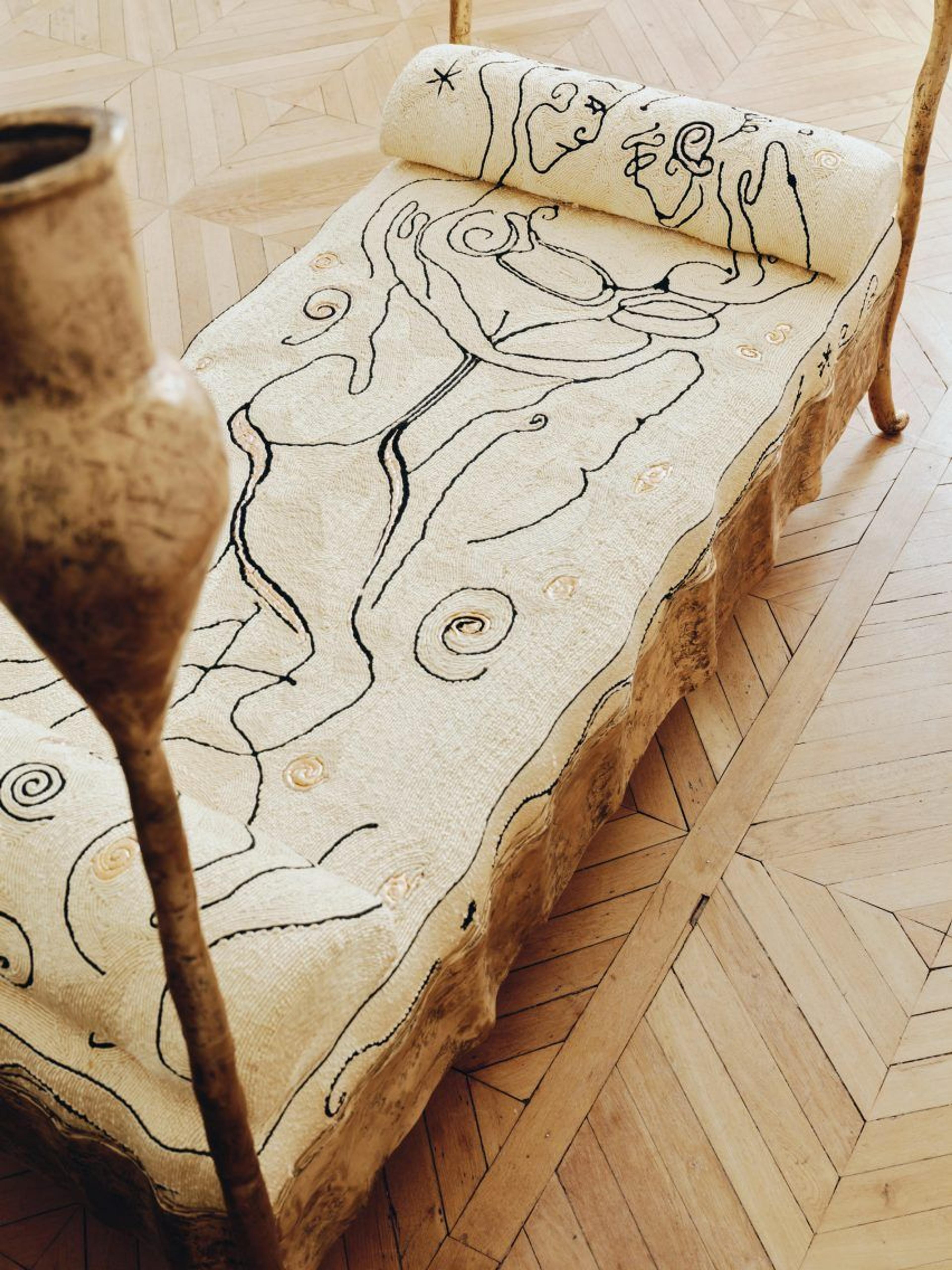 A modern bench featuring an elegant swirl motif in its design.