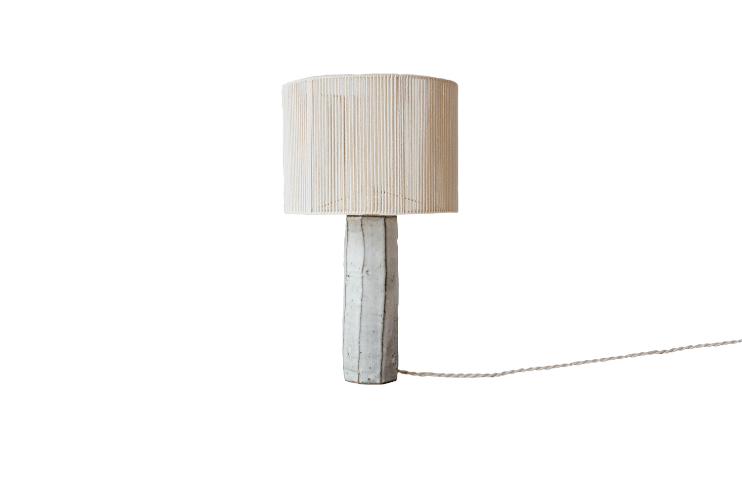 A handmade Phoebe table lamp by Aurélie Lécuyer on a bedside table.