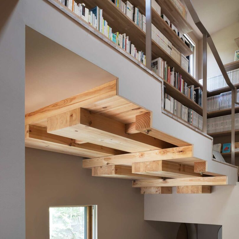 Close-up of a staggered kitchen ceiling that follows the geometric lines of the staircase above.