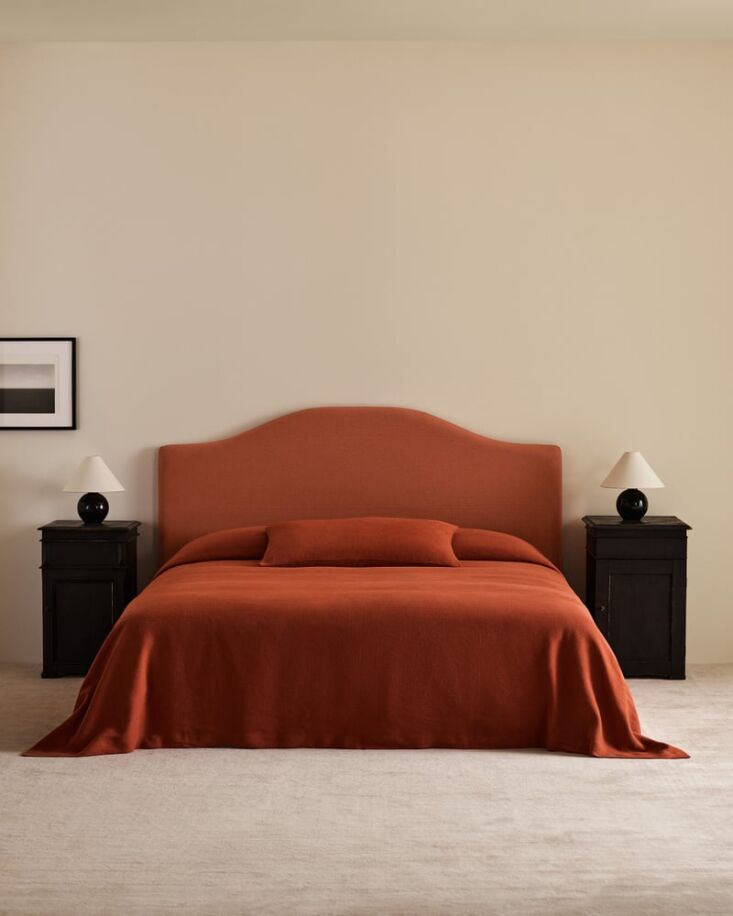 A Studio Linen Bed Cover in Burnt Red from Nordic Knots displayed in a modern bedroom.