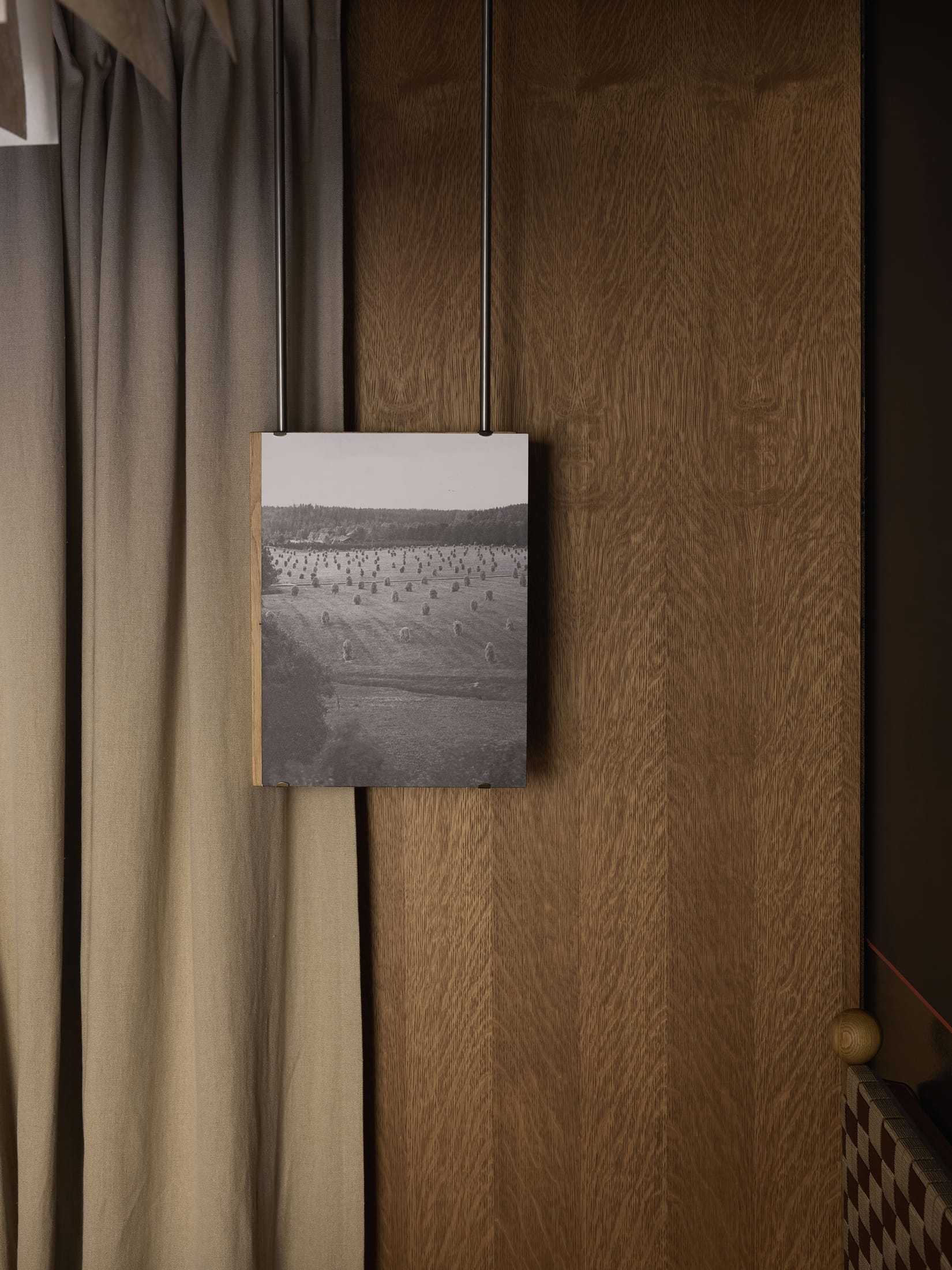 Spacious dining area with wooden tables and custom chairs in a sunlit room.