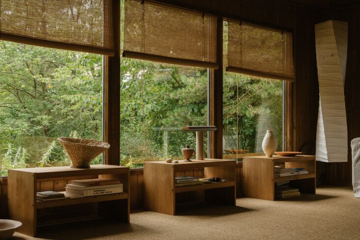 Three small side tables under three windows, featuring a stainless steel Frama T-Lamp.